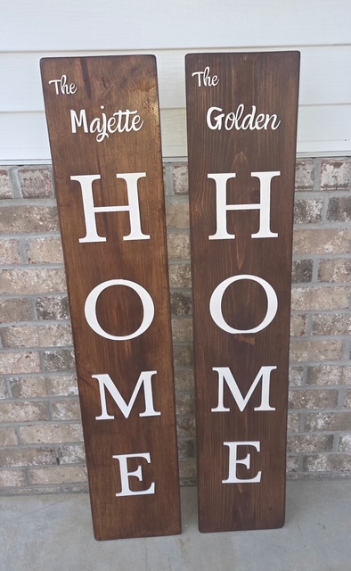 Two engraved wooden porch signs reading “The Majette HOME” and “The Golden HOME”